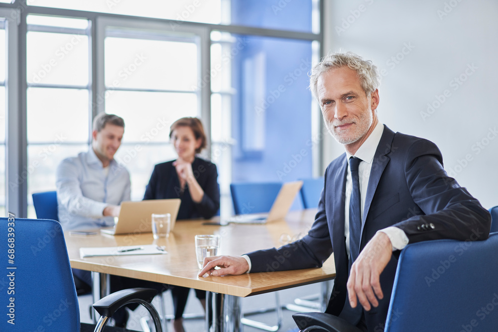 Portrait of confident manager during a meeting in office Portrait of confident manager during a meeting in office