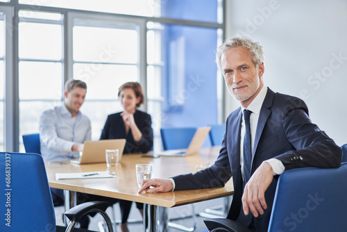 Portrait of confident manager during a meeting in office