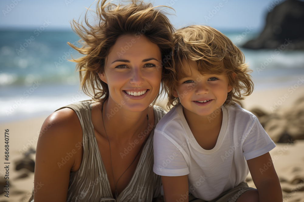 Cheerful mother spending time with her child on the sea beach, family having fun on the summer beach, sea background. Happy family concept