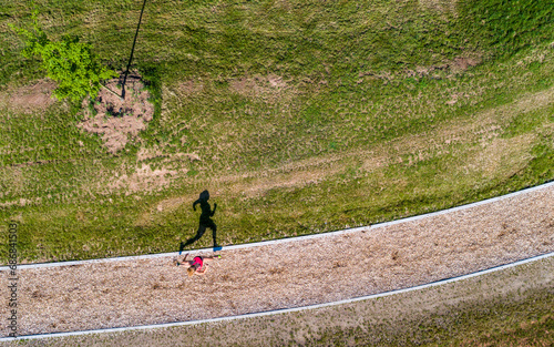 Aerial view of female jogger on woodchip trail