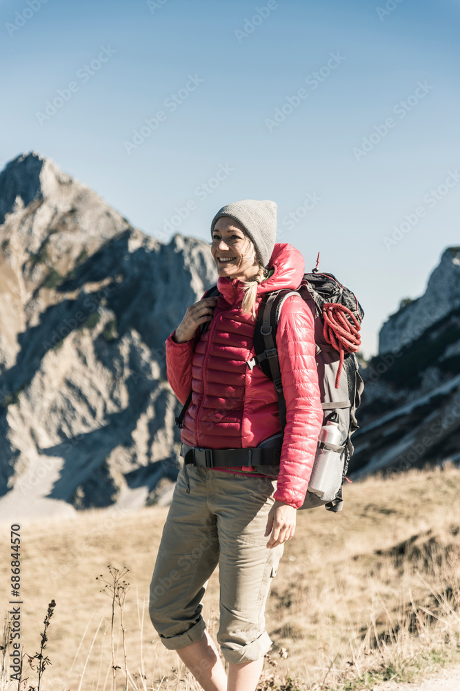 Austria, Tyrol, smiling woman on a hiking trip in the mountains