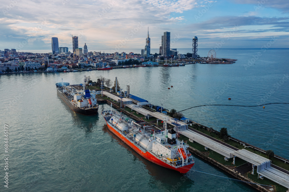 Fototapeta premium Ship tankers with LPG, oil or chemical production. Process of loading of tanker in the port, drone aerial view