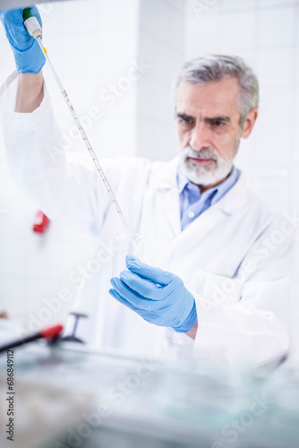 Scientist working in lab pipetting