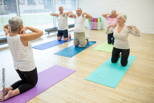 Group of active seniors practicing yoga together