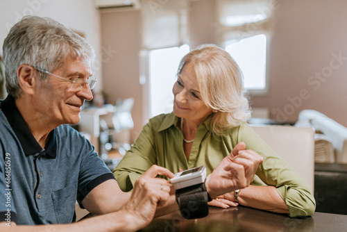 Smiling senior couple taking blood pressure photo
