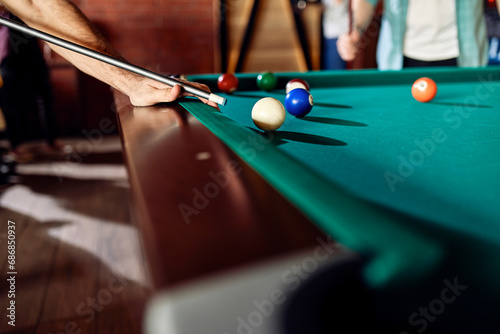 Close-up of man playing billiards photo