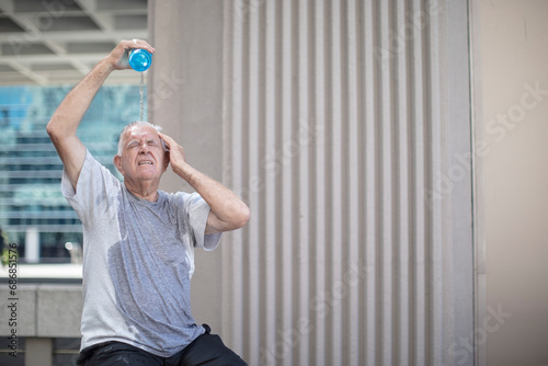 Senior athlete taking a break pouring water over his head