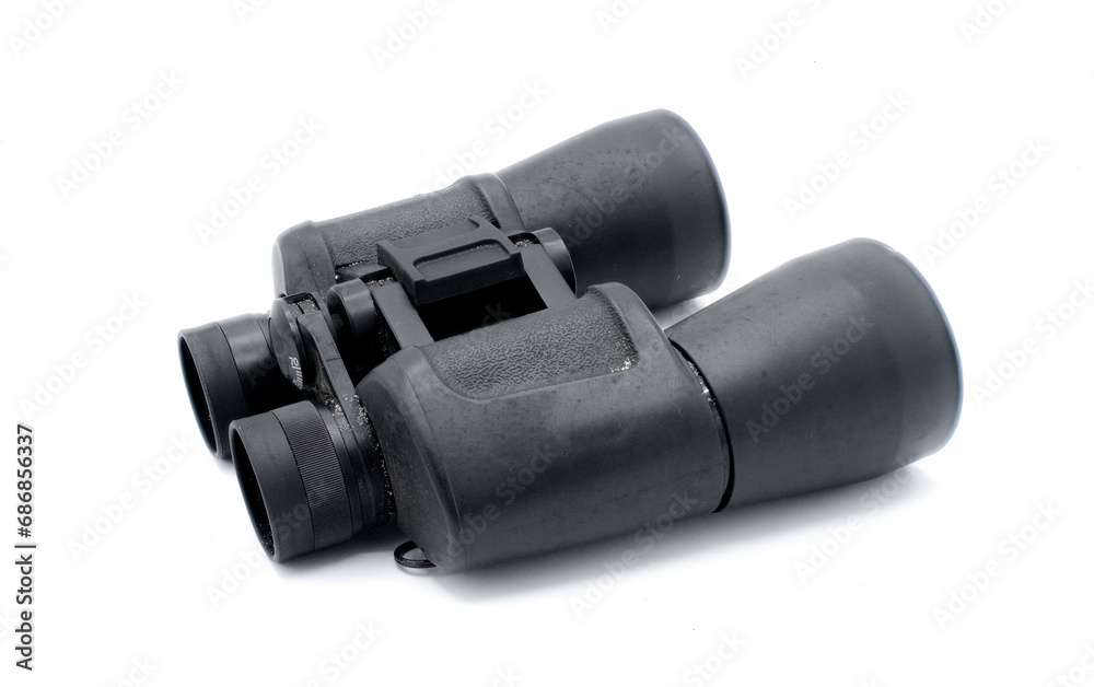 A pair of black rubber grip metal binoculars isolated on white background. Well worn, used, dirty full of sand from being out in the field viewing wildlife. Side bottom view A pair of black rubber grip metal binoculars isolated on white background. Well worn, used, dirty full of sand from being out in the field viewing wildlife. Side bottom view