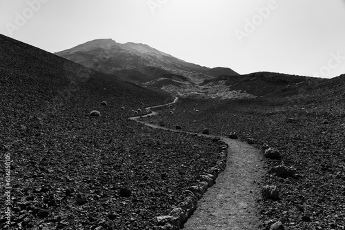 Trail to volcano Pico Viejo - the second highest peak of Tenerife. Typical volcanic landscape. Canary Islands. Spain. Black and white. photo