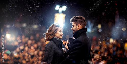 couple in love joyfully on a date in winter on stage