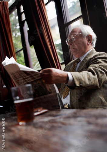Man Reading Newspaper in Pub photo