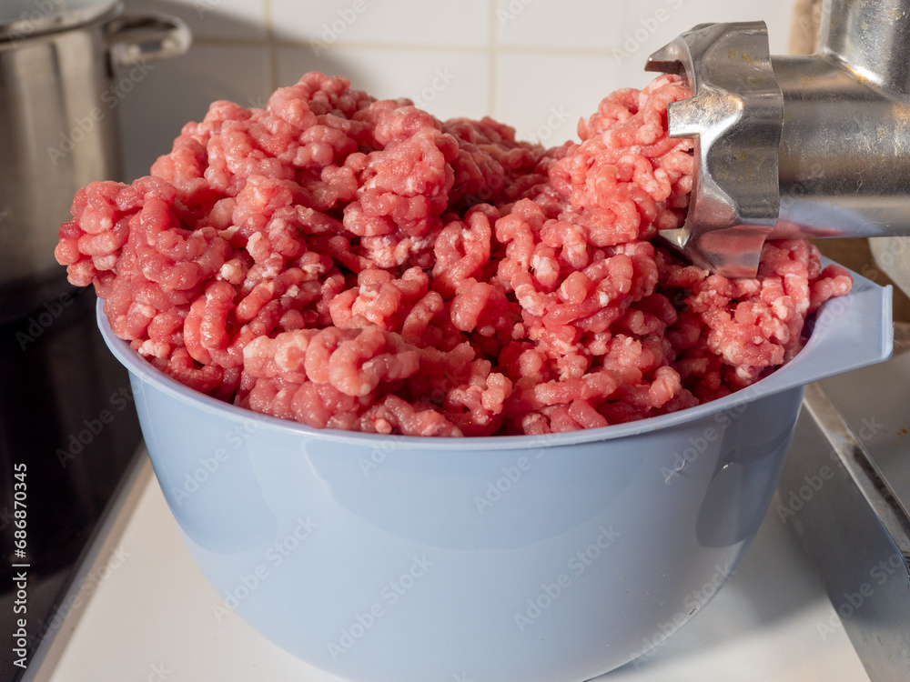 An electric meat grinder grinds meat into minced meat. Electric meat grinder close up An electric meat grinder grinds meat into minced meat. Electric meat grinder close up