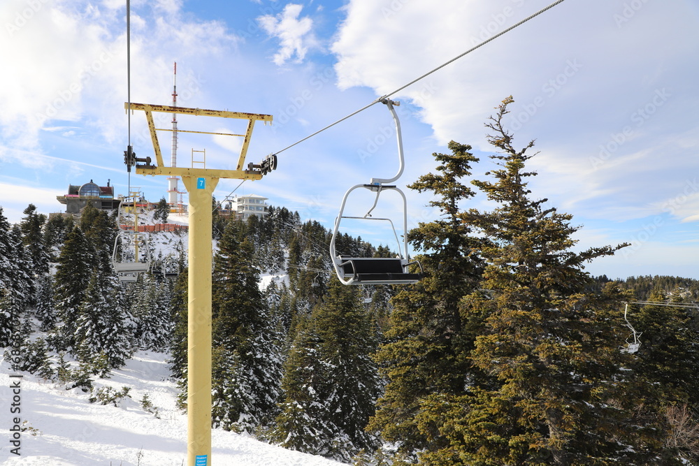 Ski Lift snowy mountain winter forest with chair lift At The Ski Resort in winter. Snowy weather Ski holidays Winter sport and outdoor activities Outdoor tourism, Bursa (Turkey), Uludağ ski lift