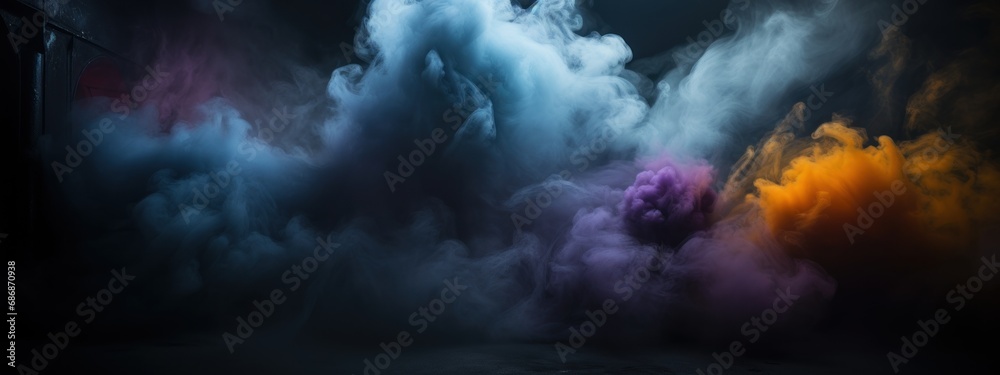 Black stage with colorful smoke below, like fog on the floor. In a dark room.