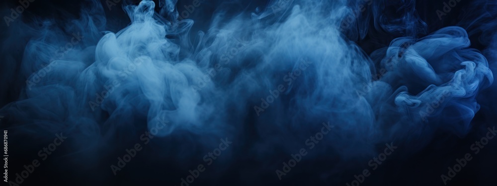 Black stage with blue smoke below, like fog on the floor. In a dark room.