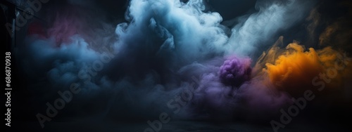 Black stage with colorful smoke below, like fog on the floor. In a dark room.