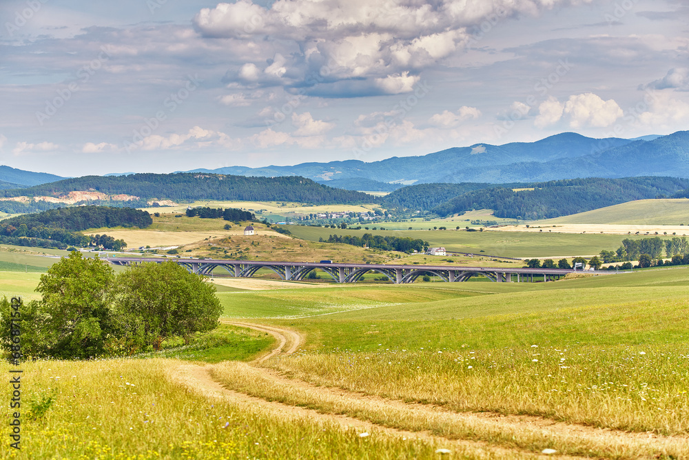Slovakia summer landscape. Green summer fields, meadows, hills of Tatra mountains. Travel in vacations. Rural Road in Spis region, Slovakia. Spissky hrad national park