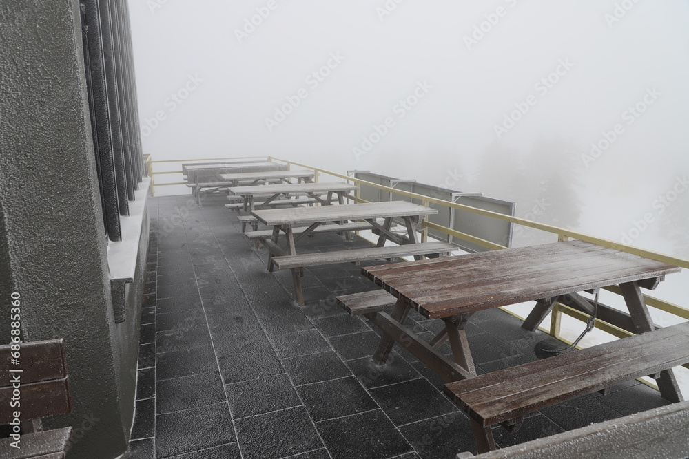 Freezing cold, frozen empty bench in Uludag, Bursa - Turkiye. frozen sitting area, frozen wooden picnic table