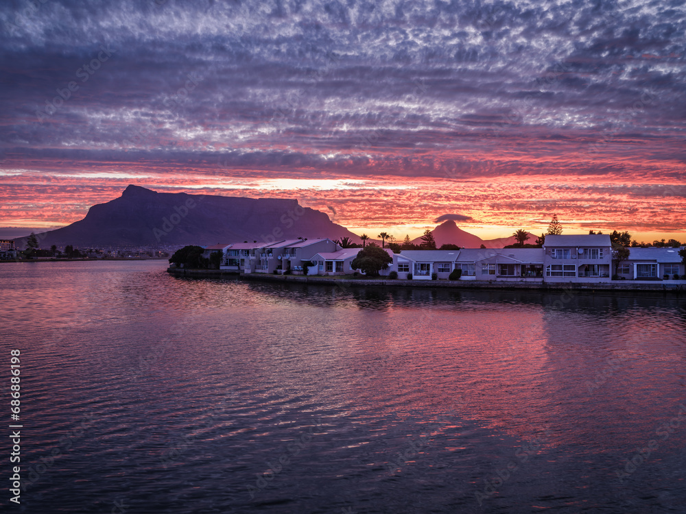 Woodbridge island and table mountain in the background with dramatic sunset, Cape Town, South Africa
