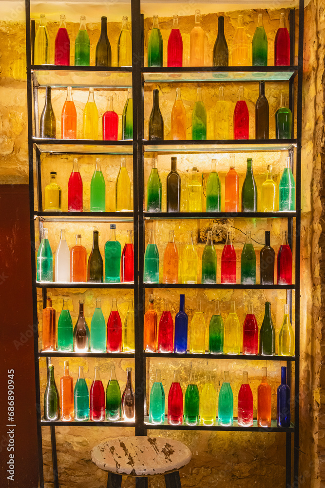 A rack of bottles filled with colored water.
