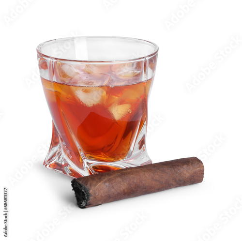 Glass of whiskey and burnt cigar isolated on white