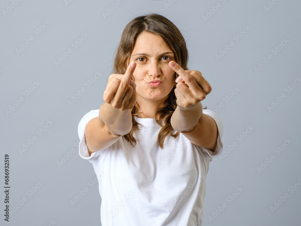 Young woman doing offensive gesture with finger over isolated Young woman doing offensive gesture with finger over isolated