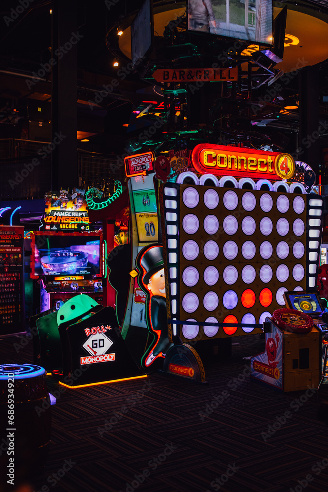 Naklejka premium Connect Four, Monopoly, Minecraft Dungeon games at Gameworks arcade in Seattle, WA