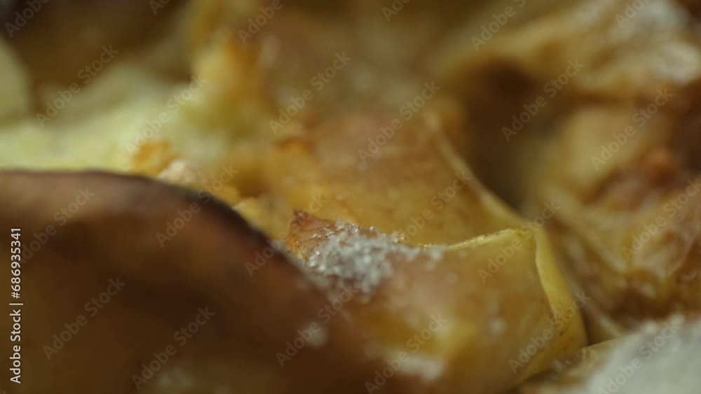 Baked apples in the oven, apples with a golden crust, sprinkled with sugar, slowly spinning Baked apples in the oven, apples with a golden crust, sprinkled with sugar, slowly spinning