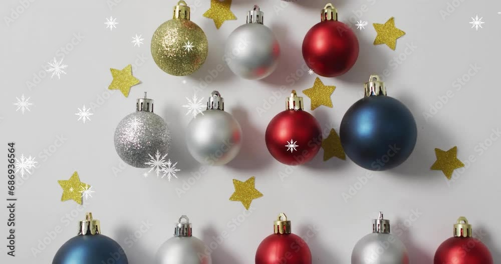 Animation of snow falling over christmas baubles and stars Animation of snow falling over christmas baubles and stars