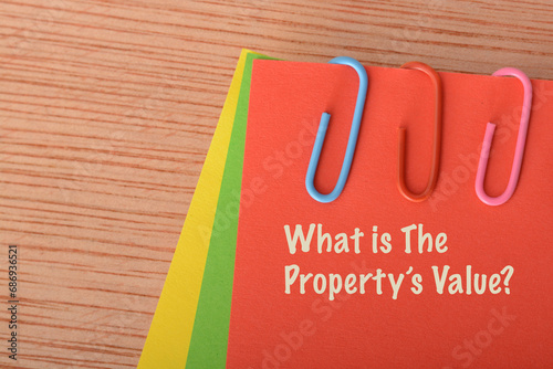 Red paper written with WHAT IS THE PROPERTY'S VALUE. photo