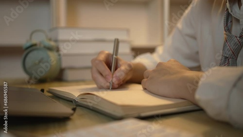 Taking note, Young Man's Hand Writing an Important Message in Notebook, Take notes of important messages, Working at night.