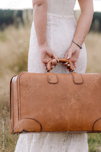 Wallpaper Mural Bride in field with a vintage suitcase Torontodigital.ca