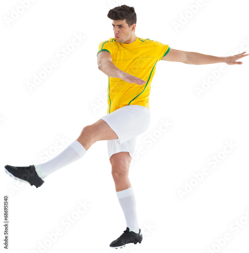Digital png photo of biracial male footballer kicking on transparent background
