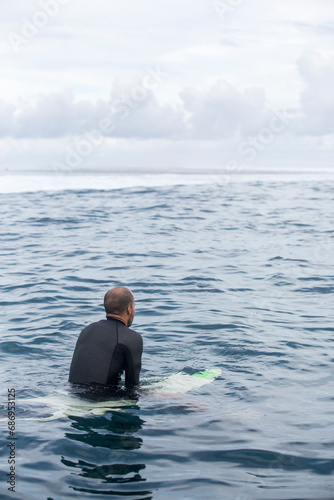 Surfing in Tahiti at sunset 
