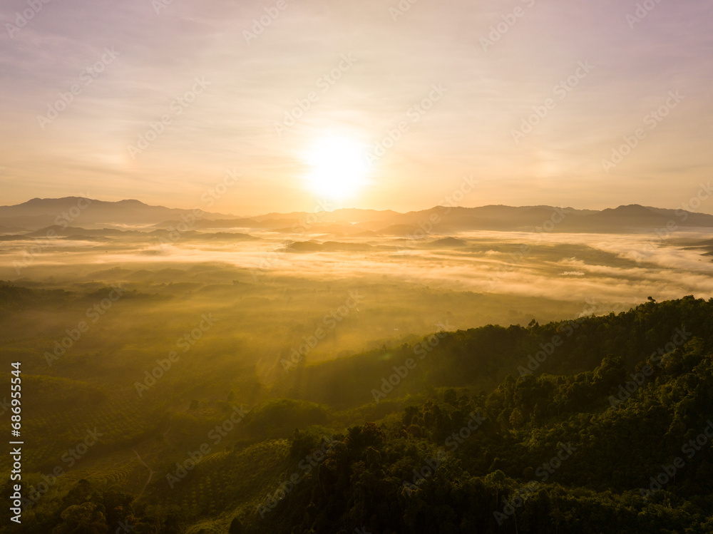 Aerial view colorful sky over mountains tropical rainforest,Bird eye view image over the fog, Amazing nature background with clouds and mountain peaks in Thailand