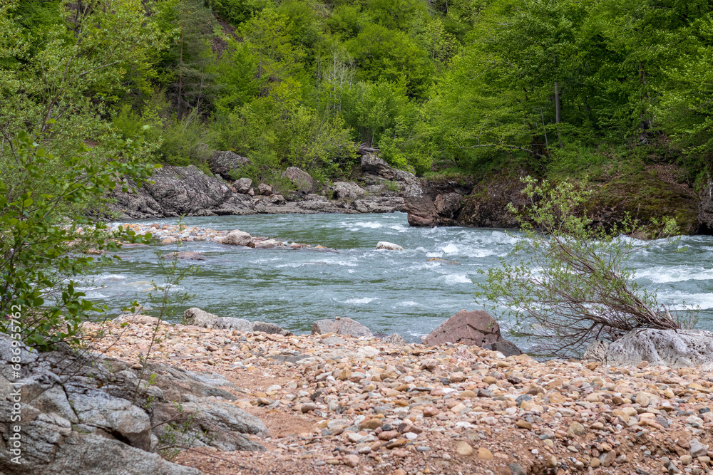 Mountain river spring season with sand and stone shoals along the banks. Mountain river spring season with sand and stone shoals along the banks.