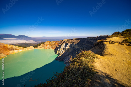 Deadwood Leafless Tree with Turquoise Water Lake,Beautiful nature Landscape mountain and green lake at Kawah Ijen volcano,East Java, Indonesia © panya99