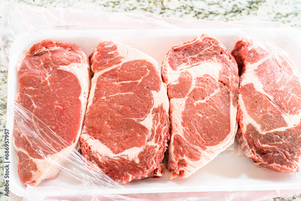 Unpacking Rib Eye Steak in Modern Kitchen Unpacking Rib Eye Steak in Modern Kitchen