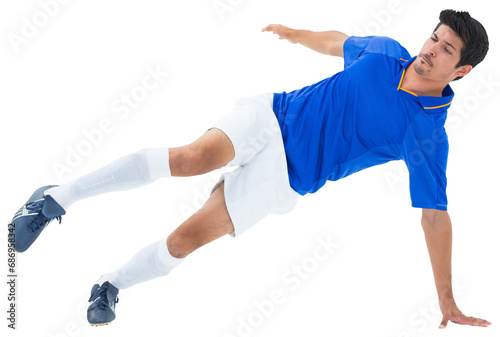 Digital png photo of biracial male footballer kicking on transparent background © vectorfusionart
