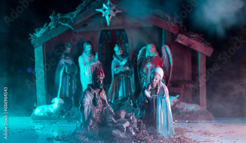 A Christmas nativity scene with baby Jesus, Mary and Joseph in the manger. Bethlehem. Christian religious. The Blessed Virgin Mary, Saint Joseph and baby Jesus. Selective focus. photo
