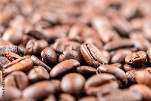 Closeup macro group roasted brown or black coffee grains background
