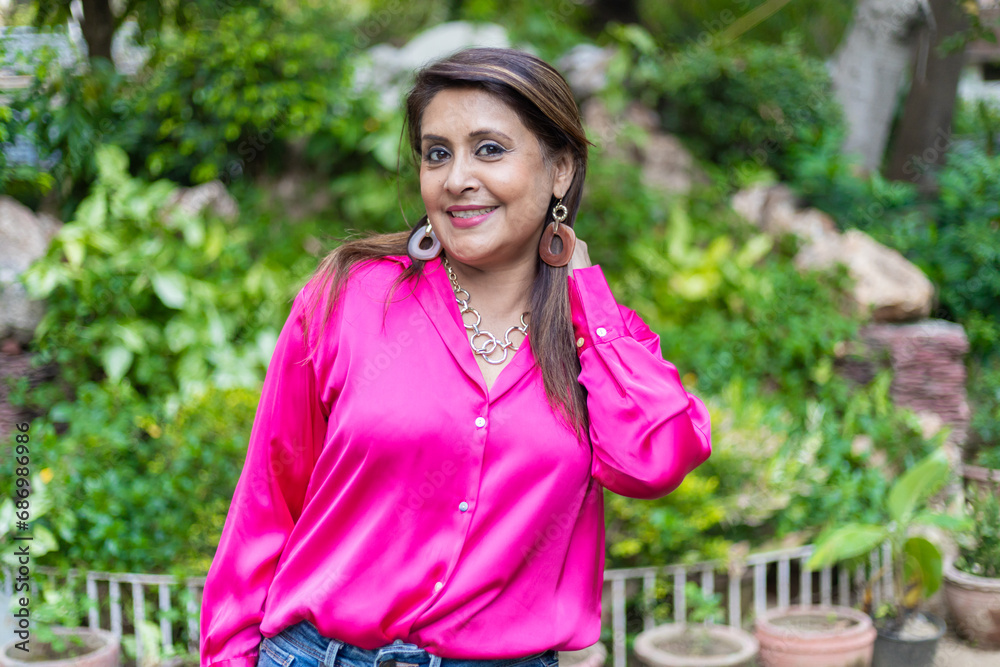 Beautiful Indian woman pink cloths in public park relaxing , enjoying in free time. Beautiful Indian woman pink cloths in public park relaxing , enjoying in free time.