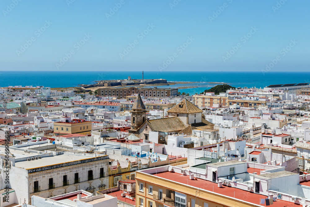 Aerial panoramic view of the old city rooftops and Cathedral de Santa Cruz in the afternoon from tower Tavira in Cadiz, Andalusia, Spain