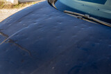 hail car hood black damaged by hailstorm hailstone dented car grey dark bonnet