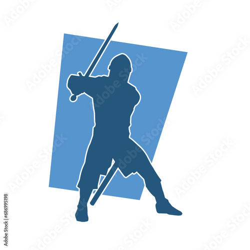 Silhouette of a male warrior wearing war armor suit in action pose using a sword weapon.