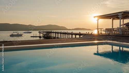 swimming pool and wooden pier in the ocean during sunset in Samaesan Thailand. photo