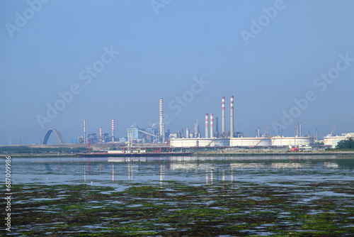 An industrial facility on the edge of a polluted water body.