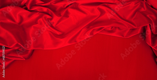 luxury red cloth or liquid wave or wavy folds of grunge silk texture satin velvet material or luxurious background or elegant wallpaper. Top view