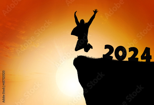 Silhouette of a person leaping from 2024 on the top of the mountain background.