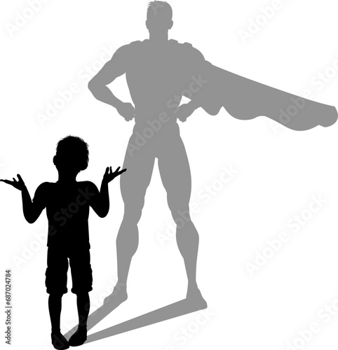 A superhero child or kid boy revealed by his shadow silhouette as a super hero in a cape.